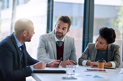 Buy stock photo Cropped shot of a group of businesspeople working together in an office