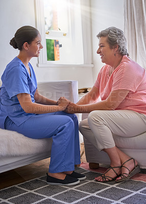 Buy stock photo Shot of a nurse holding a senior woman's hands in comfort