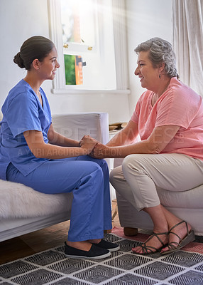 Buy stock photo Holding hands, caregiver and elderly woman on couch with advice for health, consulting or compassion. Lens flare, nurse and senior patient for hope, trust or medical conversation at retirement home