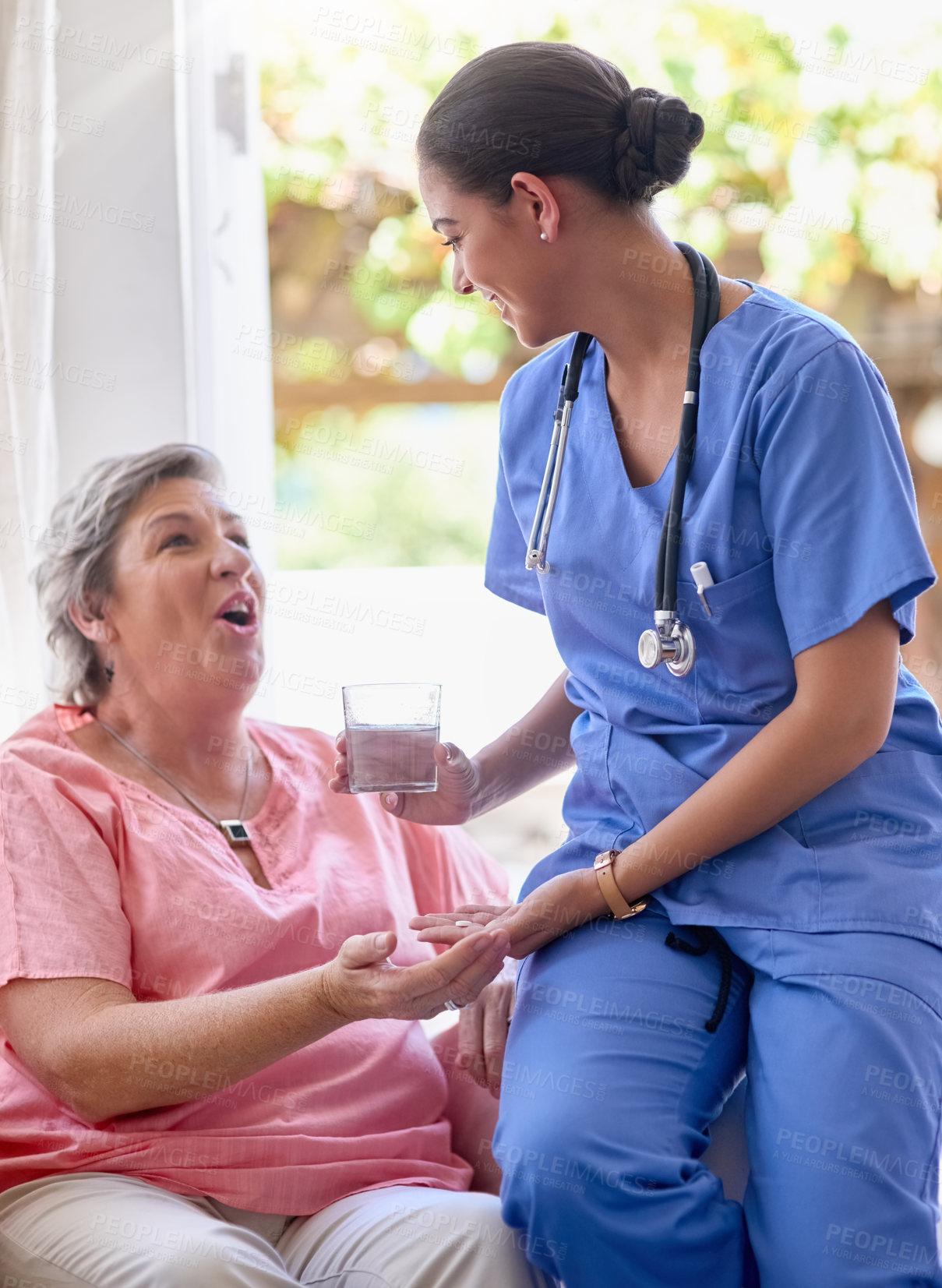 Buy stock photo Cropped shot of a nurse giving medication and a glass of water to a senior patient