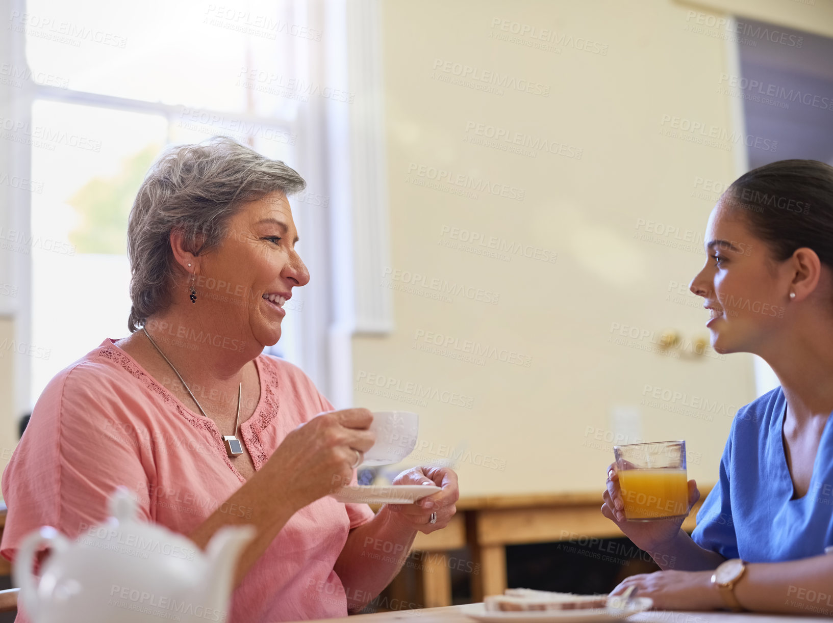 Buy stock photo Woman, conversation and caregiver of advice in nursing home for breakfast, relax or support of medical assistance. Nurse, patient and talk for senior care by helping, trust or counselling service
