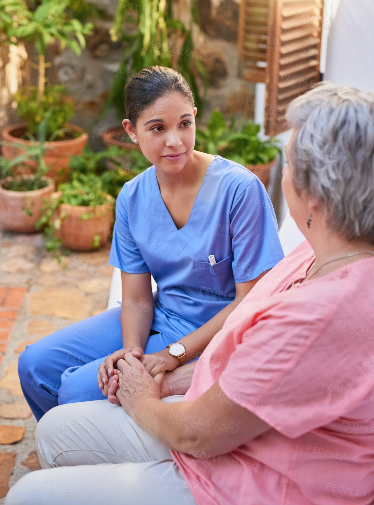 Buy stock photo Holding hands, caregiver and senior woman in garden for consultation, kindness and mental health. Listen, discussion and medical worker or nurse and retired female person outdoor for chat and support