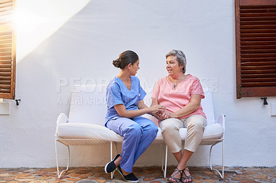 Buy stock photo Shot of a caregiver chatting to a senior patient outside