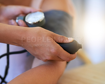 Buy stock photo Closeup shot of a nurse checking a patient's blood pressure