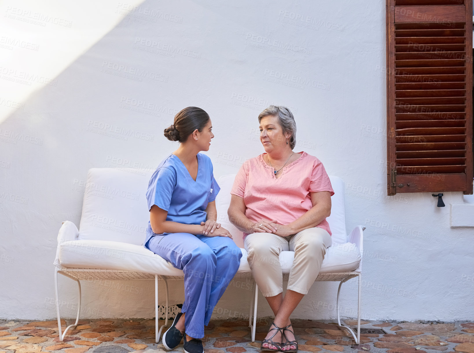 Buy stock photo Therapy, caregiver and senior woman outdoor for consultation, kindness and mental health. Chat, discussion and medical worker or nurse with retired female person on bench for conversation and advice