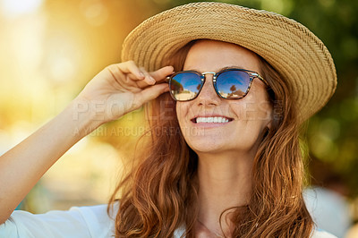 Buy stock photo Shot of an attractive young woman enjoying a summer’s day outdoors
