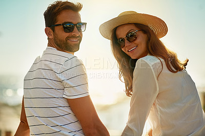 Buy stock photo Shot of a happy young couple enjoying a summer’s day outdoors