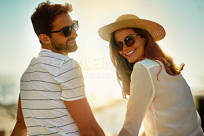Buy stock photo Shot of a happy young couple enjoying a summer’s day outdoors