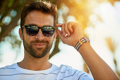 Buy stock photo Happy, sunglasses and portrait of a man in an outdoor park while on a summer vacation, adventure or holiday. Smile, confidence and young male person with eyewear standing in a garden on weekend trip.
