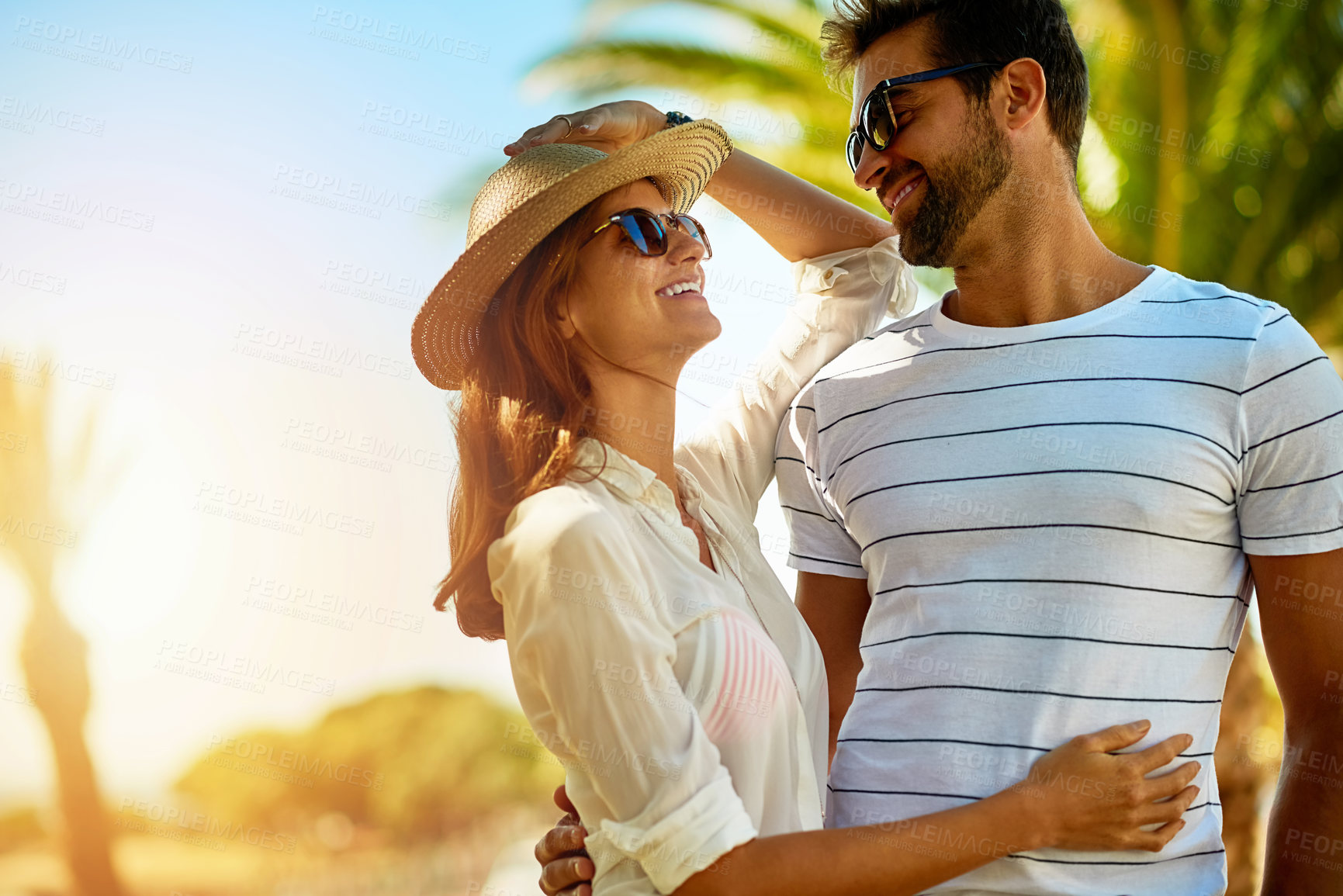 Buy stock photo Relationship, people and happy on hug in outdoor with sunglasses for summer holiday, relax and fun in Spain. Couple, love and smile with support on vacation, trip and travel together as soulmate