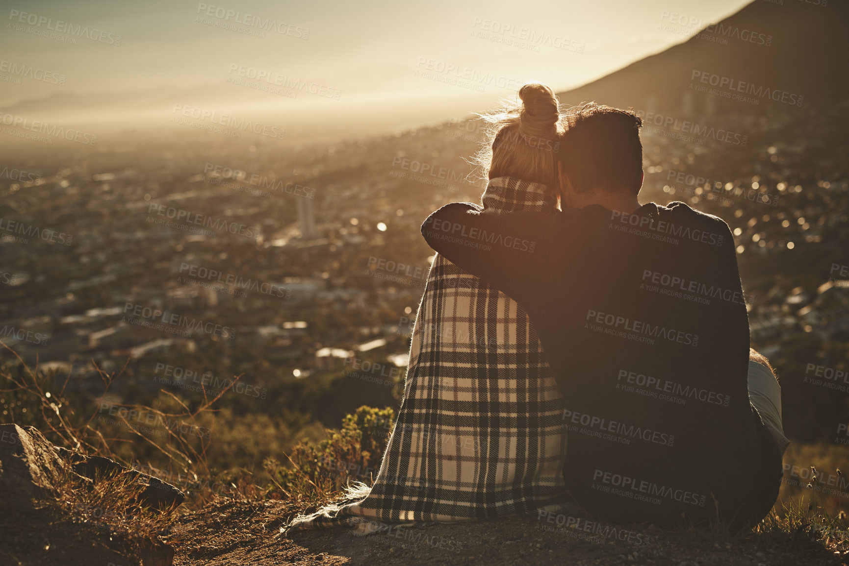 Buy stock photo Couple, hiking and love with sunrise on mountain for morning adventure, scenery and explore with embrace. Back, people and trekking on expedition for sightseeing, relax and blanket on cliff in nature