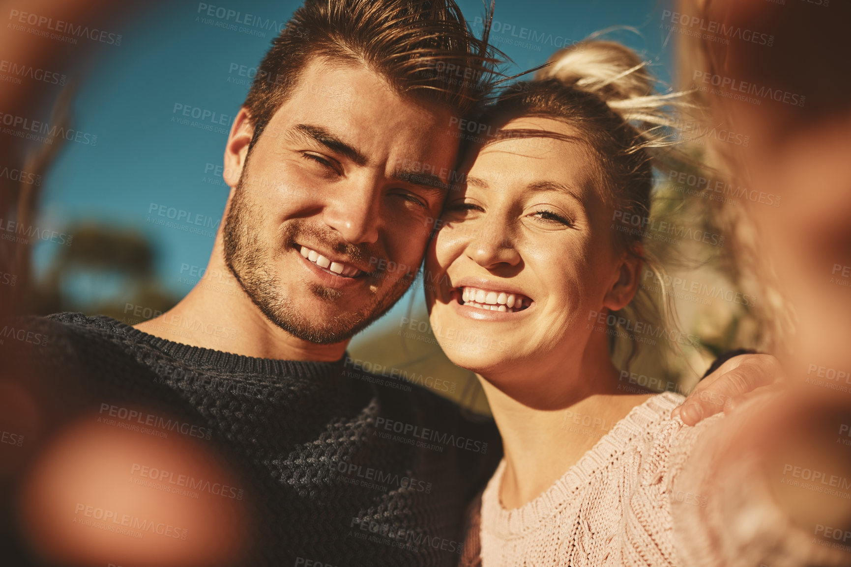 Buy stock photo Cropped shot of an affectionate couple spending the day outdoors