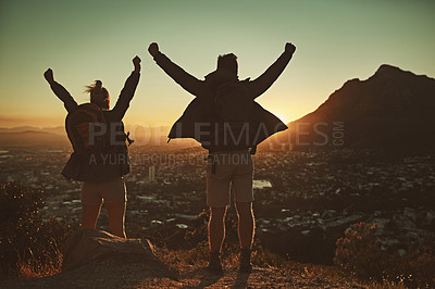 Buy stock photo Shot of a couple celebrating after reaching the summit