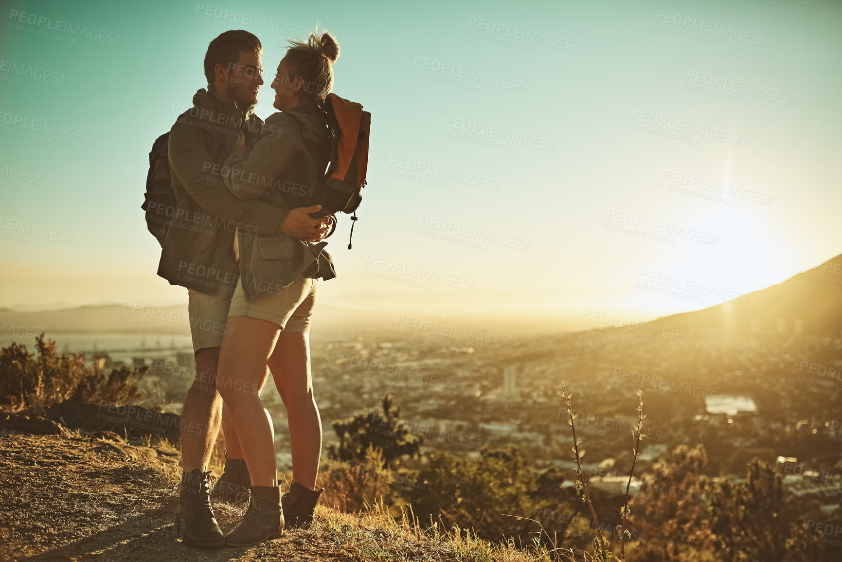 Buy stock photo Hiking, couple and love on mountain top for travel, adventure and sunset with cityscape. Man, woman and together in nature for trekking, hug and support for date and summer or holiday in Los Angeles