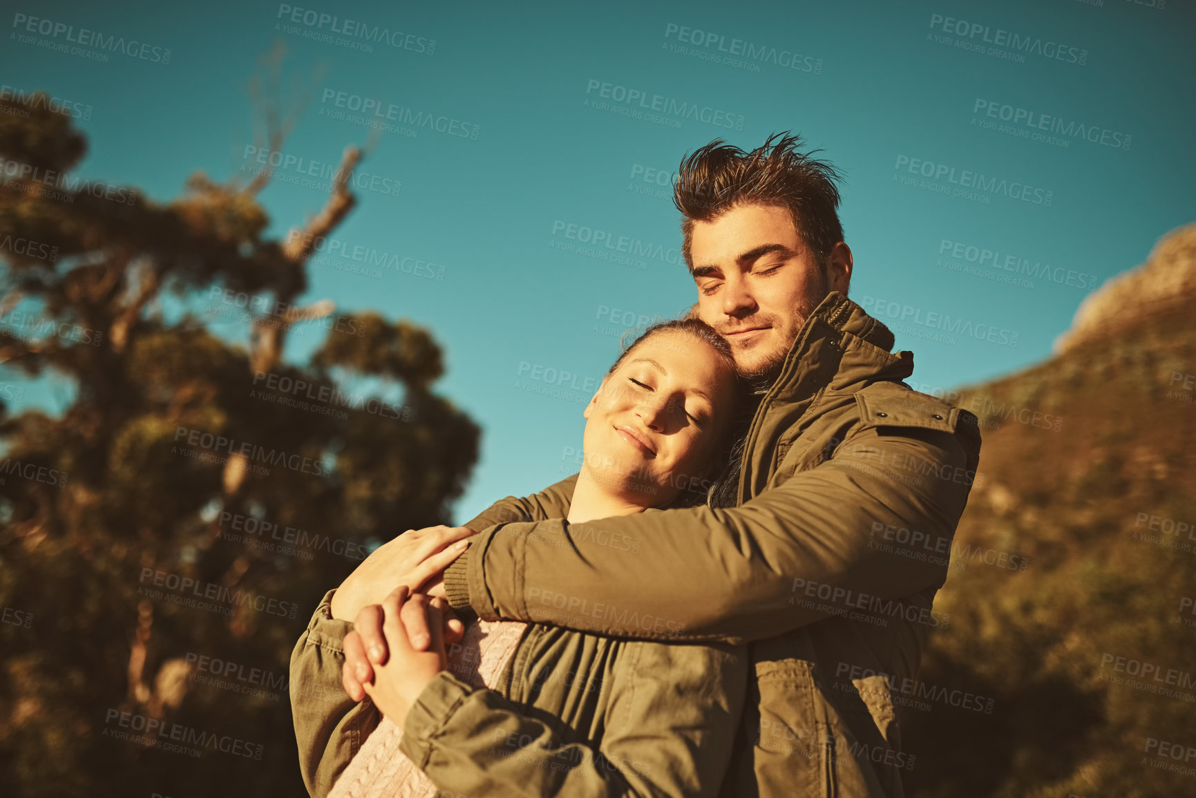 Buy stock photo Travel, man and woman on mountain for hug, hiking or calm with love for adventure. Peace or zen, couple and together in nature for trekking, sunset and support or outdoor for date, care and vacation 