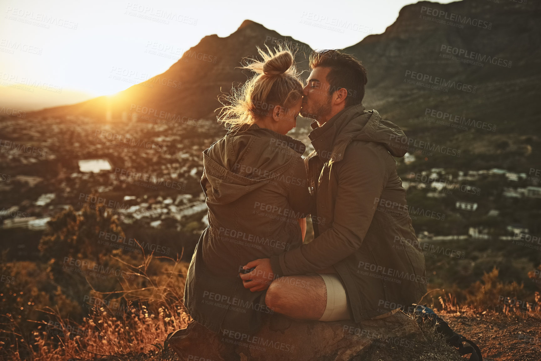 Buy stock photo Cropped shot of an affectionate couple on a mountain top