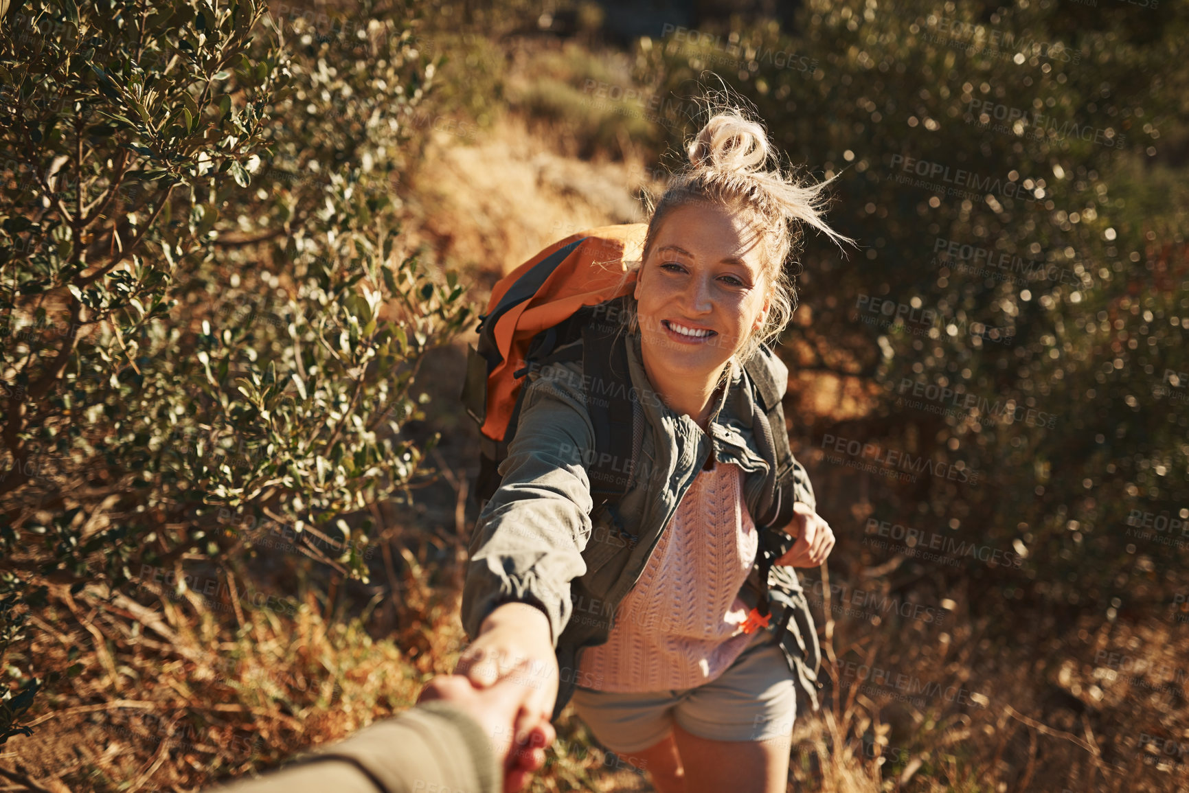 Buy stock photo Hiking, woman and smile at person for help, assistance and support on mountain trail. Female climber, trekking and holding hands with person to overcome challenge, adventure and trust in relationship