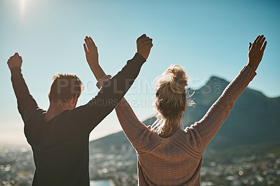 Buy stock photo Shot of a couple celebrating after reaching the summit