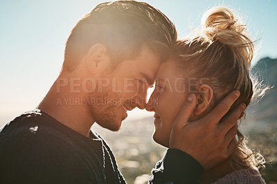 Buy stock photo Cropped shot of an affectionate couple on a mountain top
