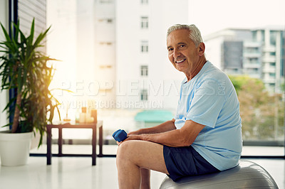 Buy stock photo Portrait of a fit senior smiling while lifting weights at the fitness center