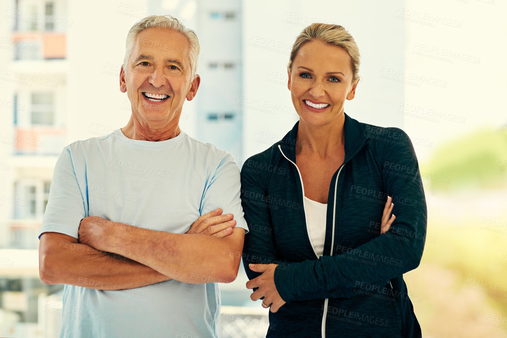 Buy stock photo Portrait of a happy physiotherapist and her senior patient posing together in a fitness center