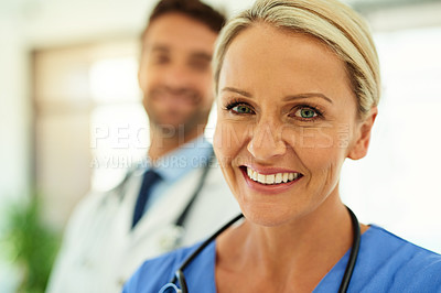Buy stock photo Portrait of two happy healthcare practitioners posing together in a hospital