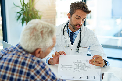 Buy stock photo Shot of a doctor consulting with a patient at his desk