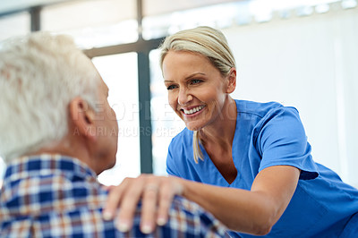 Buy stock photo Shot of a friendly healthcare practitioner putting a comforting hand on her patient's shoulder