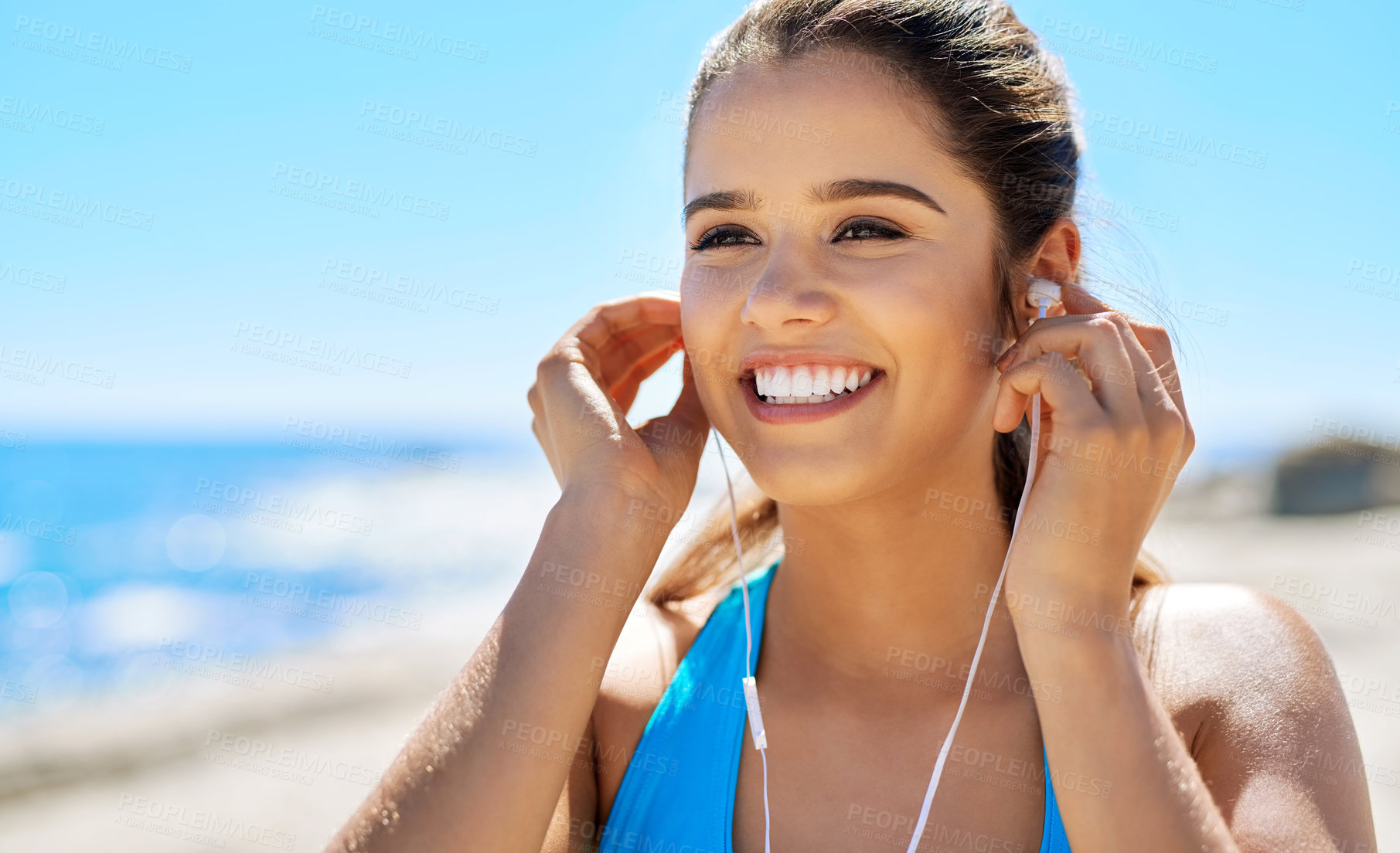 Buy stock photo Earphones, fitness and happy woman by beach for running with music, podcast or radio online. Sport, tech and female athlete streaming workout playlist for cardio exercise for marathon training by sea