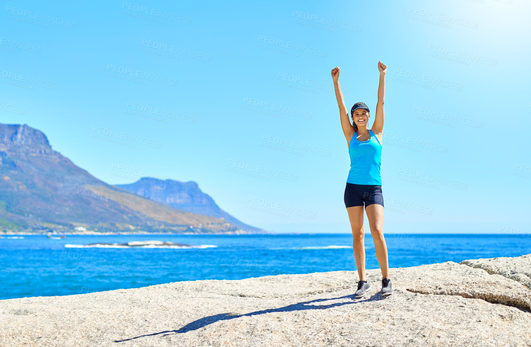 Buy stock photo Shot of a young woman celebrating her victory while out for a run