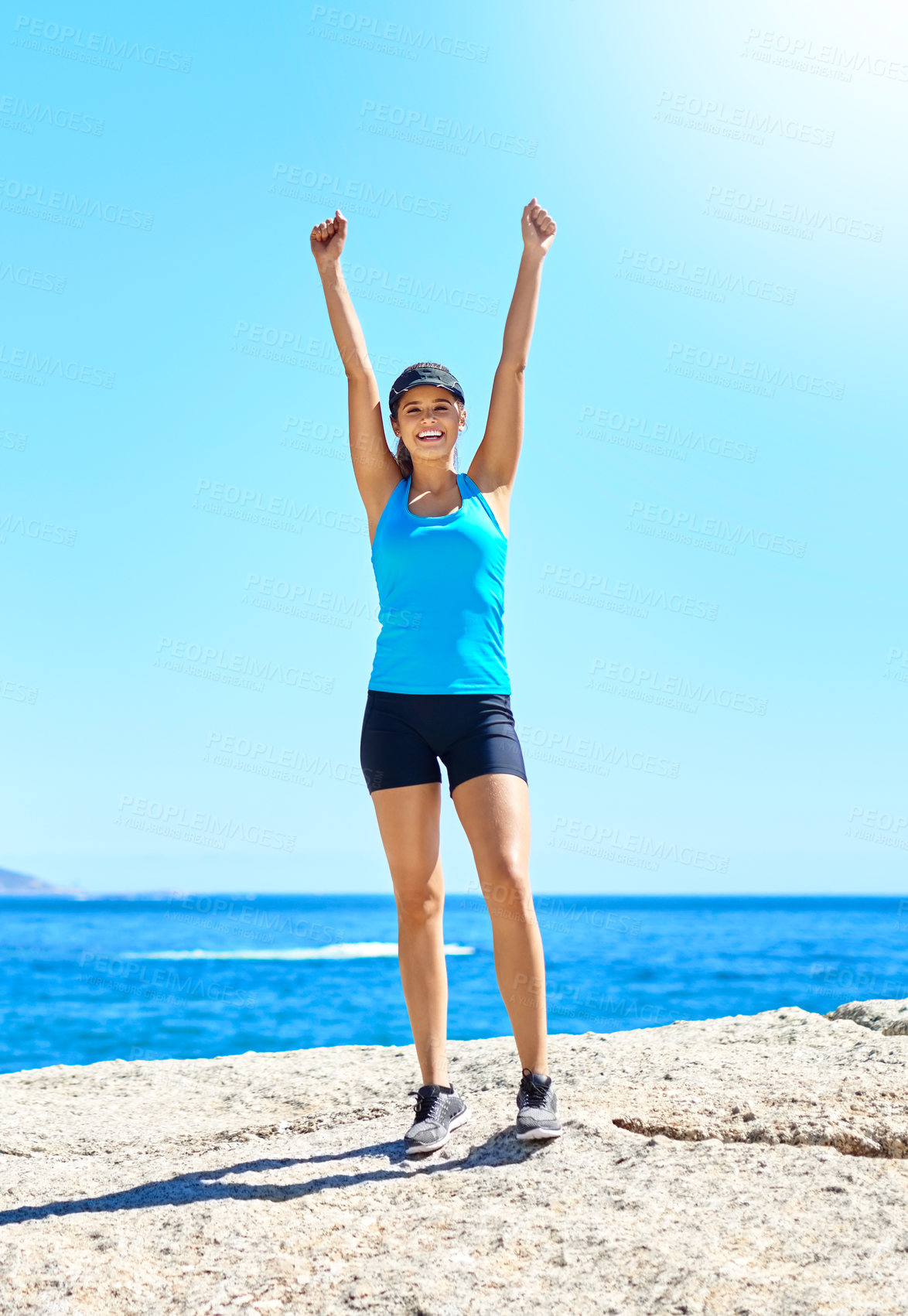 Buy stock photo Shot of a young woman celebrating her victory while out for a run