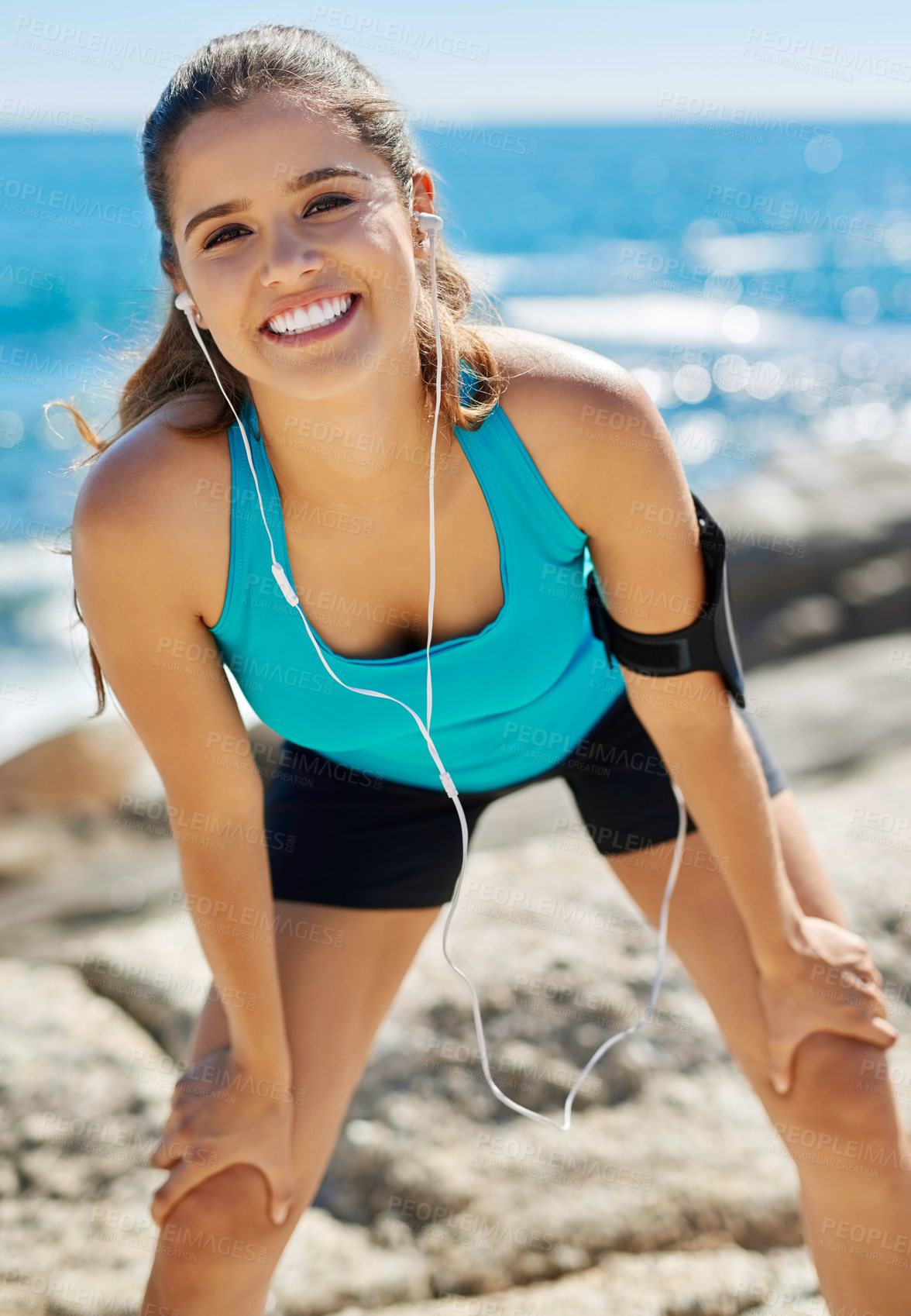 Buy stock photo Earphones, portrait and woman by beach for running with music, podcast or radio online. Fitness, tech and female athlete streaming workout playlist for cardio exercise for marathon training by sea