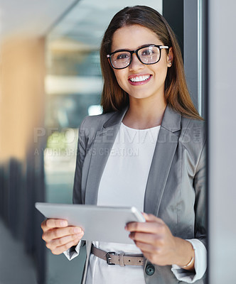 Buy stock photo Cropped portrait of an attractive young businesswoman using her tablet in the office