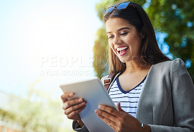 Buy stock photo Cropped shot of an attractive young woman using her tablet while commuting to work