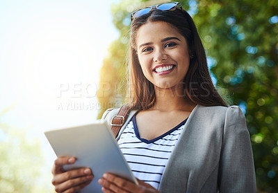 Buy stock photo Cropped portrait of an attractive young woman using her tablet while commuting to work