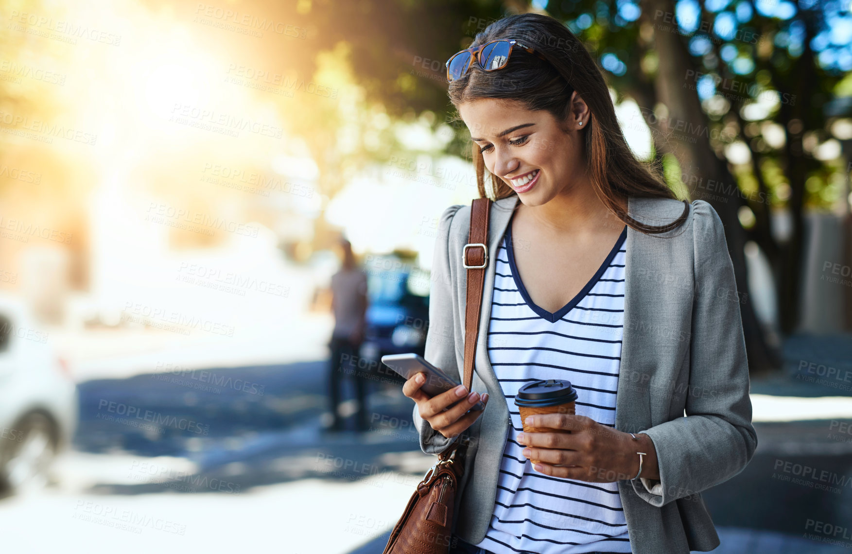 Buy stock photo Outdoor, woman and happy on smartphone with coffee for social media post and networking, Female person, employee and smile in street to travel for work or office on internet or website for news