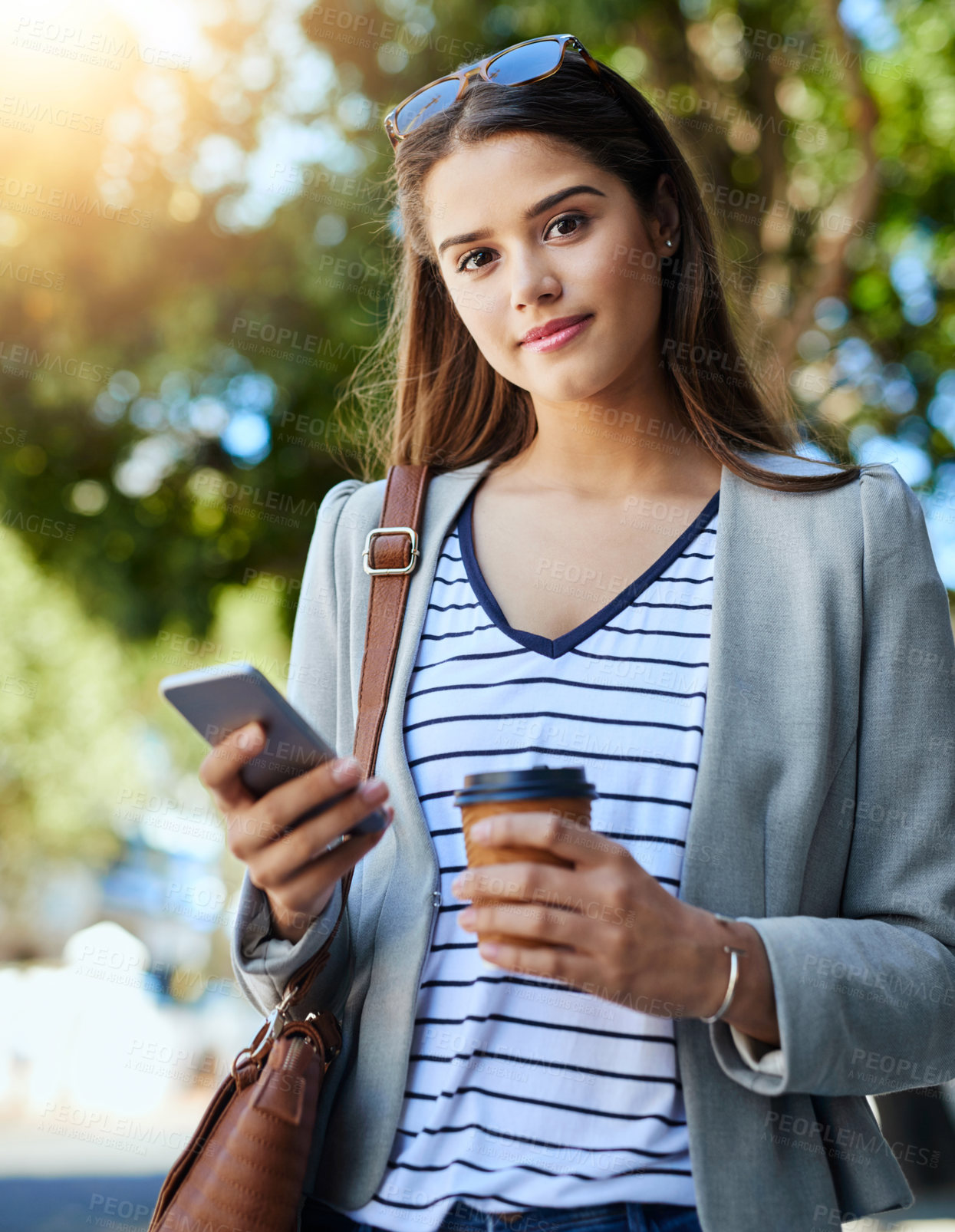 Buy stock photo Cropped portrait of an attractive young woman using her cellphone while commuting to work