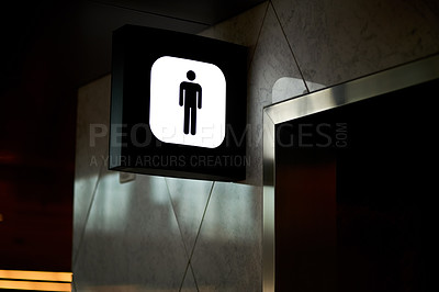 Buy stock photo Low angle shot of the sign in a public building indicating above a male restroom