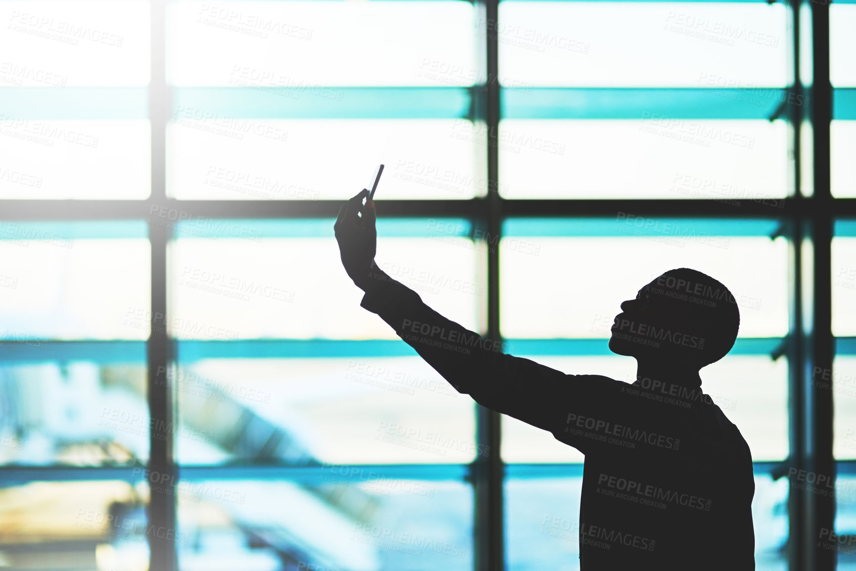 Buy stock photo Silhouette, phone and man for selfie in airport, international departure and social media post at terminal. Male person, photography and website for plane information, waiting area and app for flight