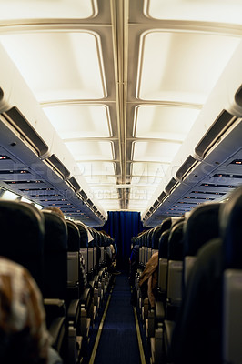 Buy stock photo Rearview shot of unidentifiable passengers seated in an airplane cabin