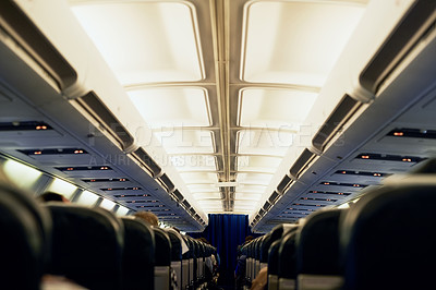 Buy stock photo Rearview shot of unidentifiable passengers seated in an airplane cabin