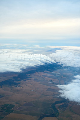 Buy stock photo Shot of a cloudy view seen from an airplane window