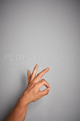 Buy stock photo Studio shot of an unidentifiable hand making an OK gesture against a gray background