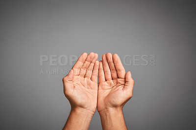 Buy stock photo Studio shot of unidentifiable hands cupped against a gray background