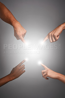Buy stock photo Studio shot of four unidentifiable hands pointing glowing fingers against a gray background
