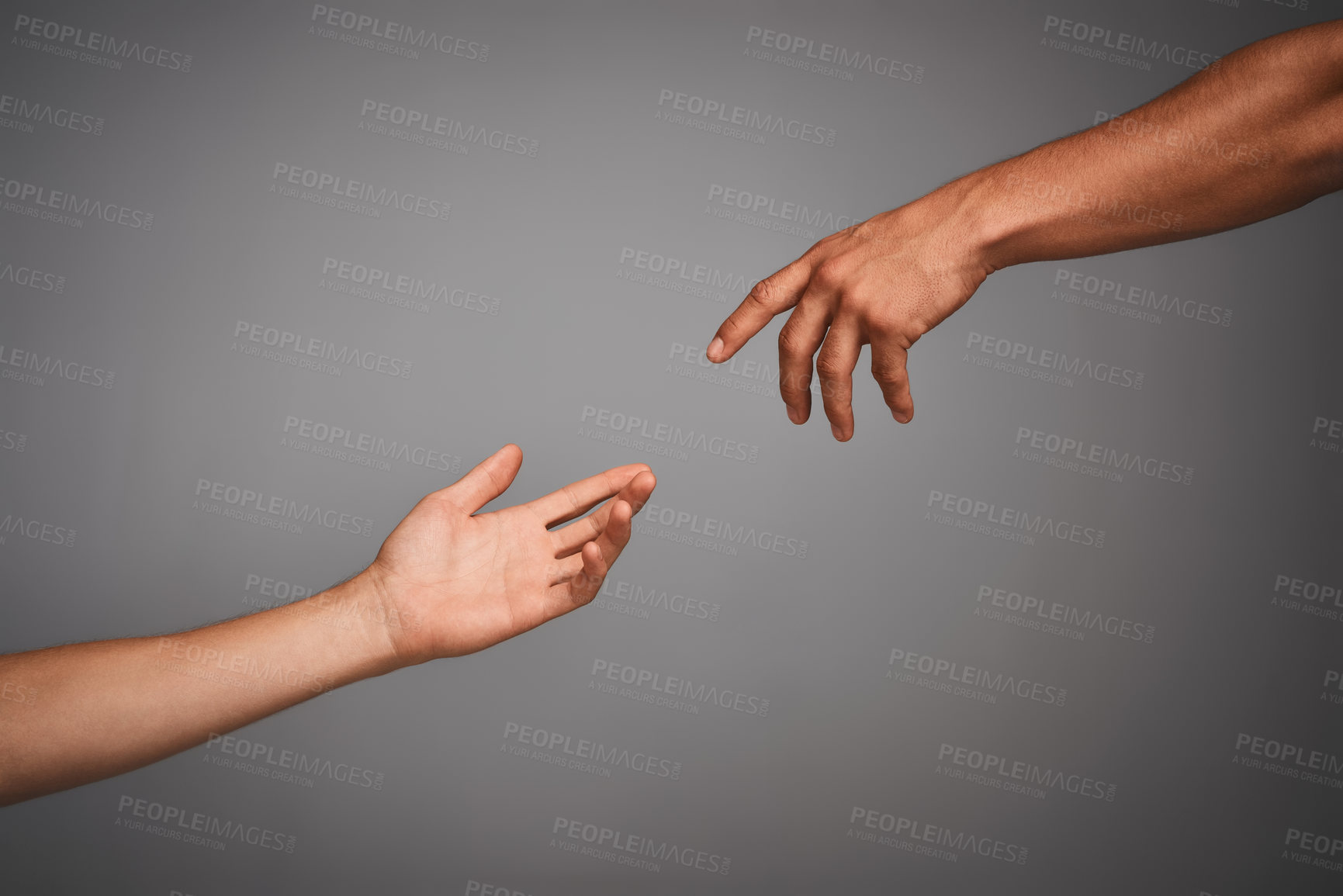 Buy stock photo Studio shot of unidentifiable hands reaching for each other against a gray background