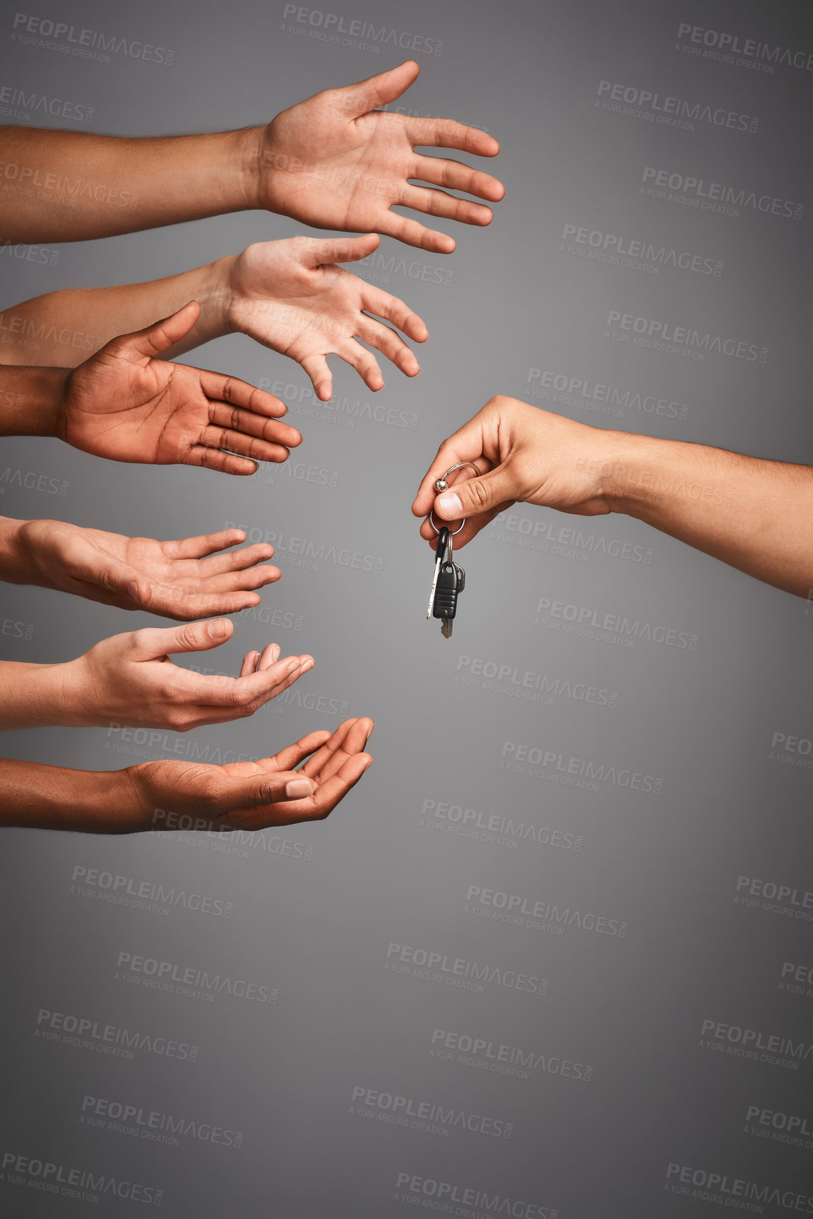 Buy stock photo Studio shot of unidentifiable hands reaching for a set of keys against a gray background