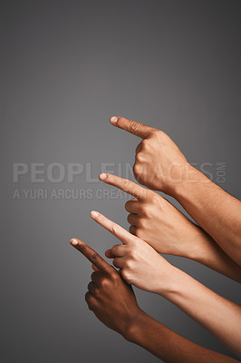 Buy stock photo Studio shot of unidentifiable hands pointing upwards towards blank copyspace