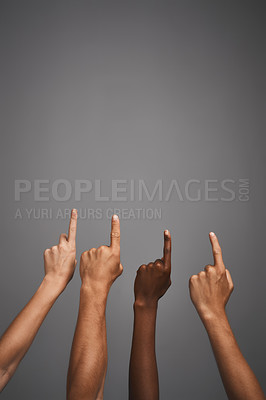 Buy stock photo Studio shot of unidentifiable hands pointing upwards towards blank copyspace