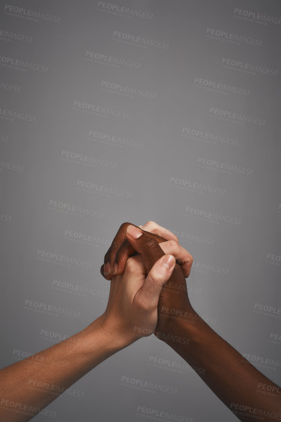 Buy stock photo Hands, holding and studio for support or unity, together and symbol of solidarity on gray background. People, fingers join and love for partnership or compassion, respect and trust on mockup space